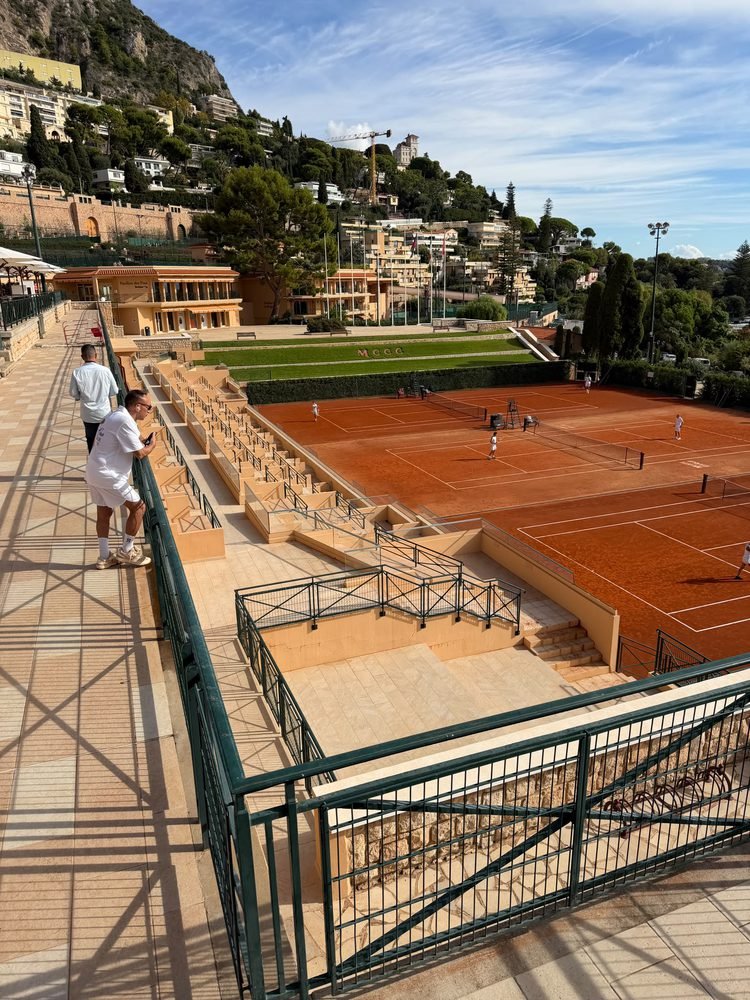 Clay courts at the Monte-Carlo Country Club seen from the terrace, with hills behind